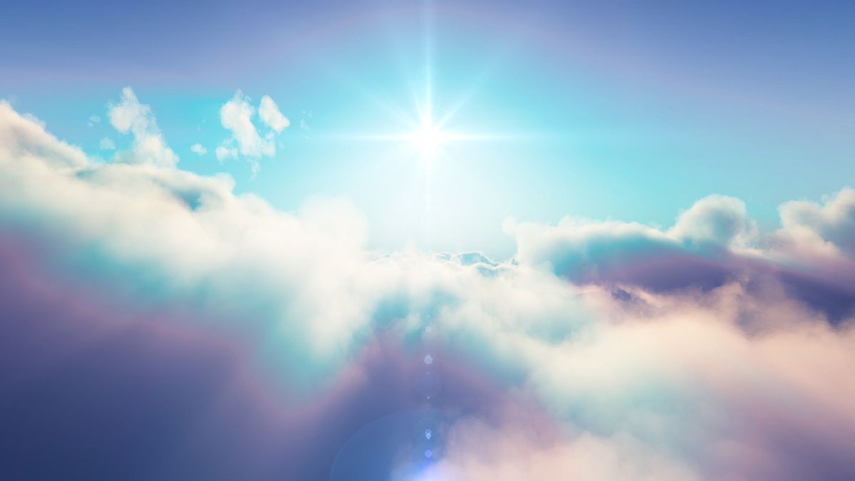 Gorgeous bright blue sky and intense sun with fluffy white clouds lined with light blue and purple edges